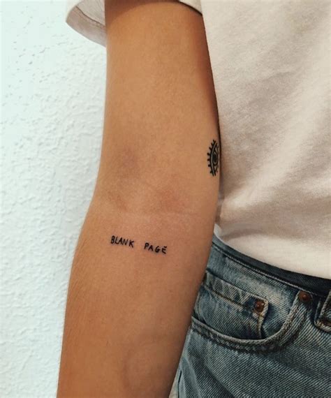 A Person With A Tattoo On Their Arm That Says Bank Note In Black Ink