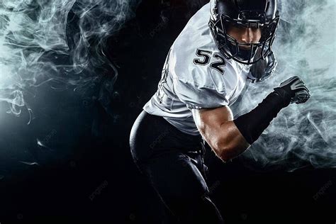 Smoky American Football Player In Helmet On Black Background A