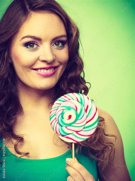 Smiling Girl With Lollipop Candy On Green Stock Photo Adobe Stock