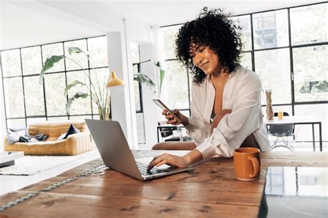 Premium Photo African American Woman Typing On Laptop Having Coffee