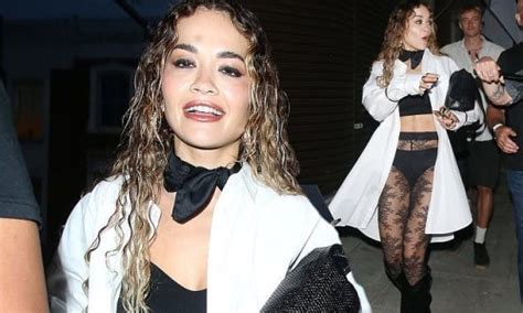 rita ora cuts a racy figure as she shows off her underwear in black lace tights and boots while