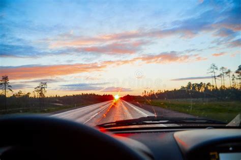 Red Sunset View With Shining Sun From The Car Front Window Driving Car
