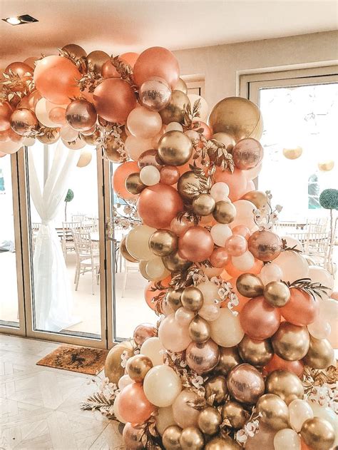 A Christmas Tree Made Out Of Balloons And Other Decorations In A Room