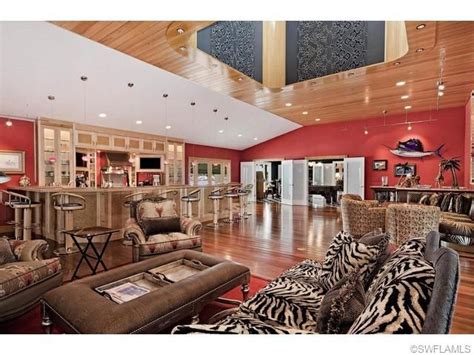 100+ best red living rooms interior design ideas. Zebra sofa couch - leather table - red walls - mounted marlin - wood ceilings - massive home bar ...