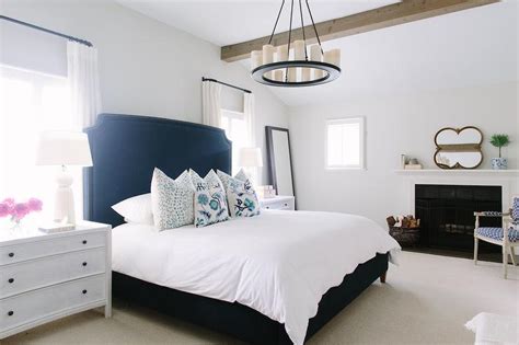 The dark navy silk drapery and navy walls create a calming oasis in this master bedroom, and the high gloss white enamel paint on the mantel pops against the navy color. White and Navy Bedroom with Fireplace - Contemporary ...