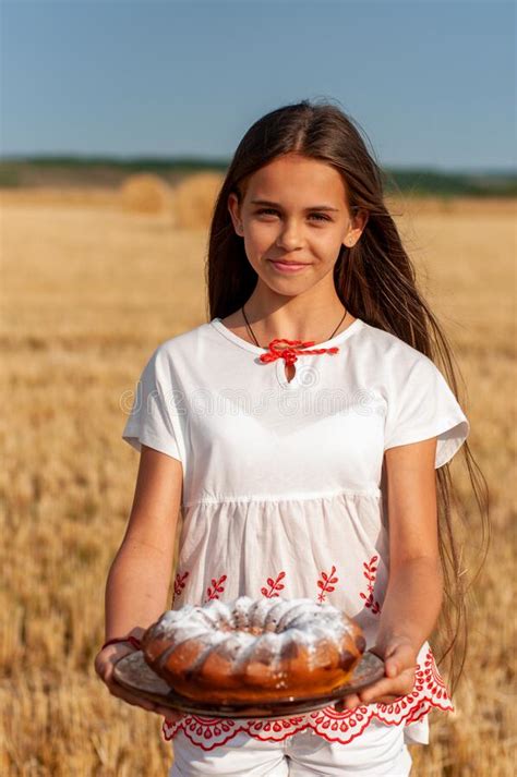 vertical portrait of a barefoot girl in a long green dress on a background of wild forest stock