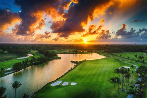 Aerial view of tropical golf course at sunset.