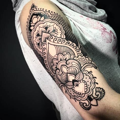 Check spelling or type a new query. Henna style upper arm tattoo on the right upper arm.