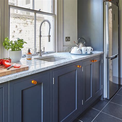 Simple yet stunning white satin lacquer, handless kitchen. Kitchen makeover with dark blue units and walnut worktops ...