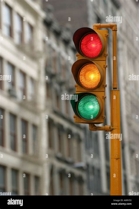 Vertical Traffic Light With Red Yellow And Green Signals Illuminated In