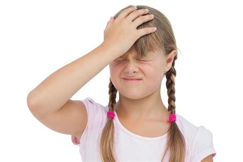 Little Girl Suffering From Headache And Touching Her Head On Whi