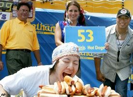 American steve addicks (r) looks on incredulously as kobayahsi consumes two hot dogs at a time. Takeru Kobayashi