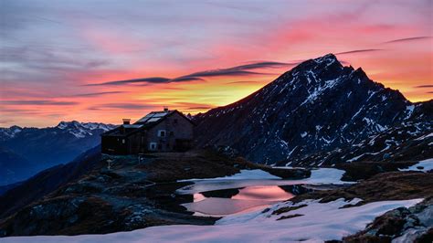 Snow Covered Mountains Stone House Yellow Black Clouds Sky Background