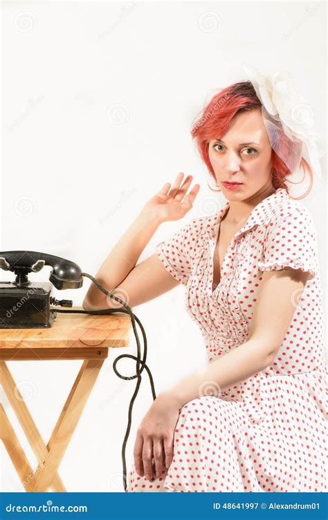 Redhead Woman With A Retro Look Waiting For The Phone Stock Image