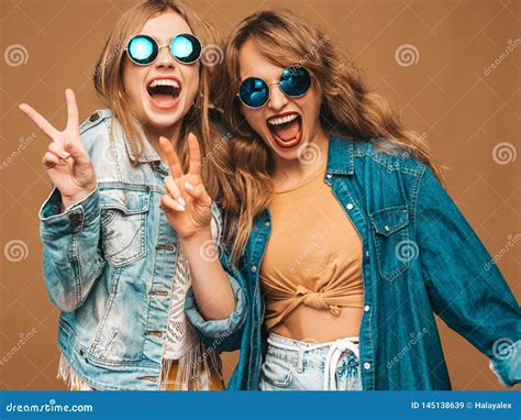 Two Young Beautiful Hipster Girls In Trendy Clothes In Studio Stock