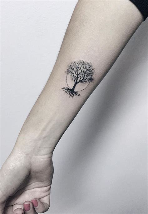 A Small Tree Tattoo On The Left Inner Forearm And Wrist Is Shown In