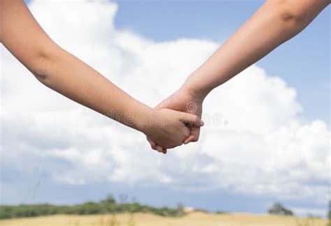 Low Angle Shot Of Two People Holdings Hands Together Friendship Love
