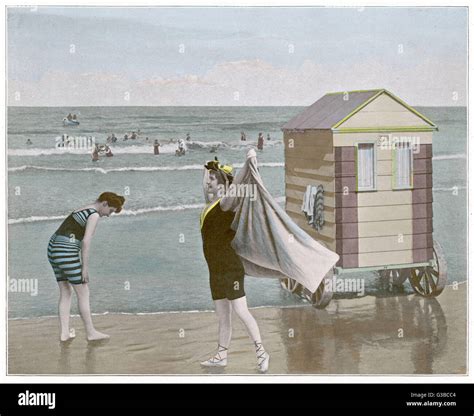Women On A Beach Beside Their Bathing Machine Date 1890s Stock Photo
