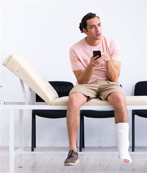 Young Injured Man Waiting For His Turn In Hospital Hall Stock Photo