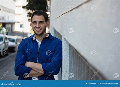 Portrait Of Smiling Young Man With Arms Crossed Stock Image Image Of