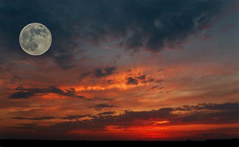 Red Sky During Sunset With A Big Moon In The Full Moon Phase And The
