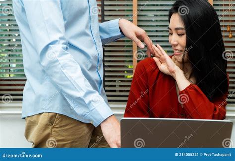Boss Touching Shoulder Of A Young Female Employee In Office At Workplace She Is Uncomfortable