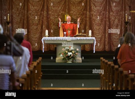 Priest Gives Blessings During Mass At St Lawrences Catholic Church In Feltham London Stock