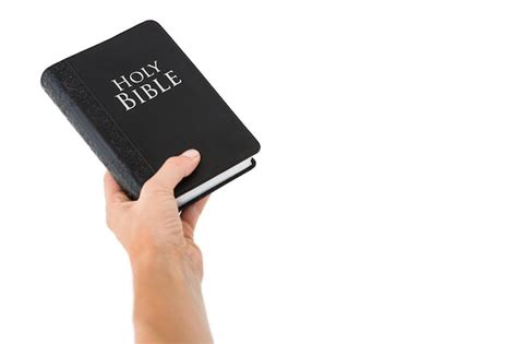 Premium Photo Hand Holding Bible