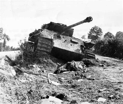 A Destroyed German Panther Tank And A Dead American Soldier In Normandy