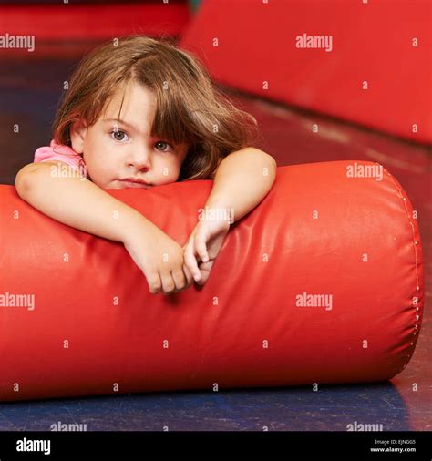 Girl Laying On Pillow For Relaxation In A Gym In Kindergarten Stock