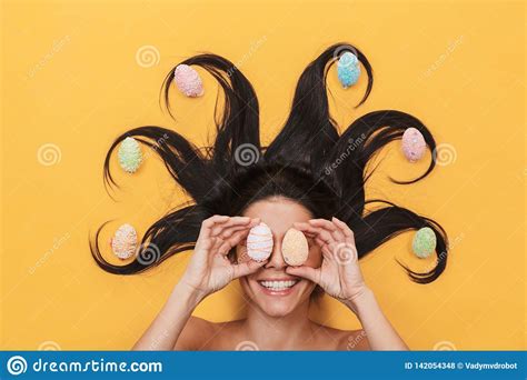 Pleased Happy Young Woman Lies Isolated On Yellow Background Over