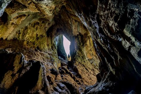 Brown And Black Cave With Blue Water Photo Free Cave Image On Unsplash