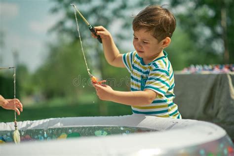 Happy Toddler Boy Playing In The Fishing Hot Summer Day Stock Image