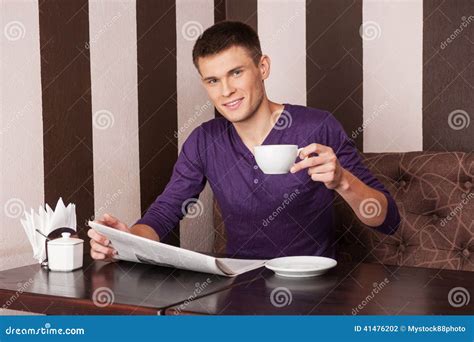 Young Man Sitting And Drinking Coffee Stock Photo Image Of Enjoyment