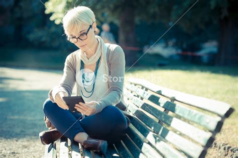 Beautiful Young Blonde Short Hair Hipster Woman Using Tablet In The