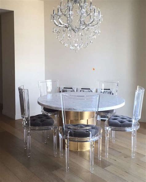 The dining set, which includes a round table. 15 Gorgeous Ghost Chairs | Ghost chair dining room ...