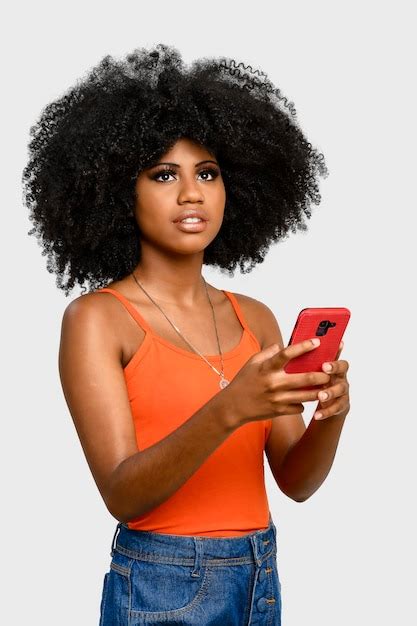 Premium Photo Young Woman With Afro Hairstyle Holding Cell Phone