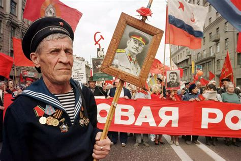 An Elderly Wwii Veteran Holds A Portrait The Late Soviet Dictator