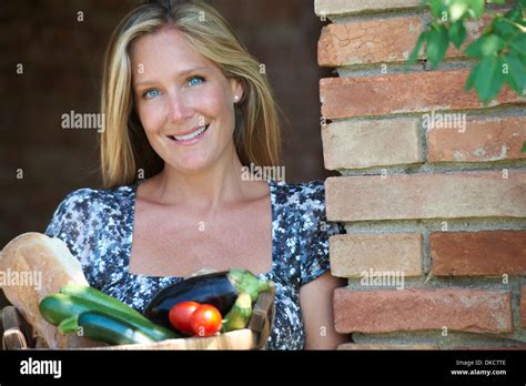 Mature Woman Standing Outside With Basket Of Organic Food Stock Photo Alamy