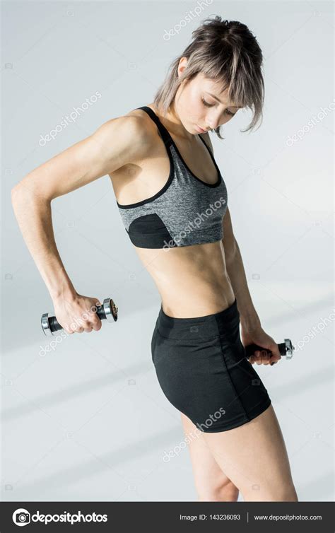Woman Training With Dumbbells Stock Photo Tarasmalyarevich
