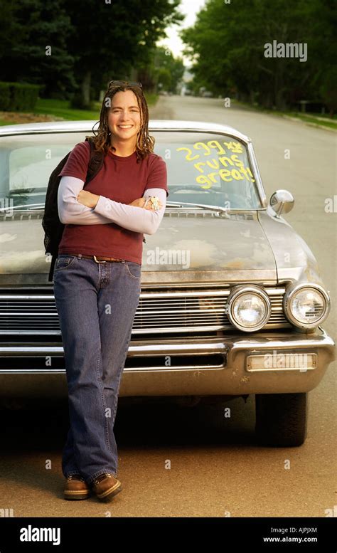 Young Woman Leaning Against A Retro Car Stock Photo Alamy
