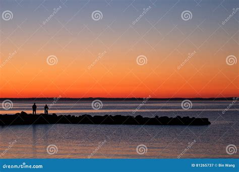 People Enjoying The Lakeside Sunset Stock Image Image Of Lakescape