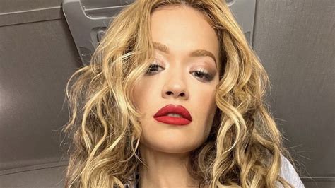 rita ora stuns as she teases fans by flashing toned abs in open shirt for sizzling snaps the