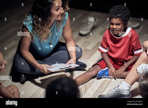 Soccer Players Listening To Coach In Locker Room Stock Photo Alamy