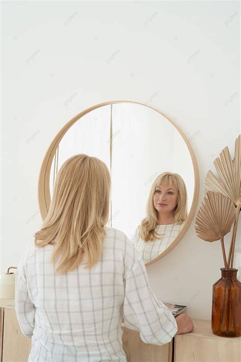 Reflection Of A Gorgeous Middleaged Blonde Woman With Long Hair