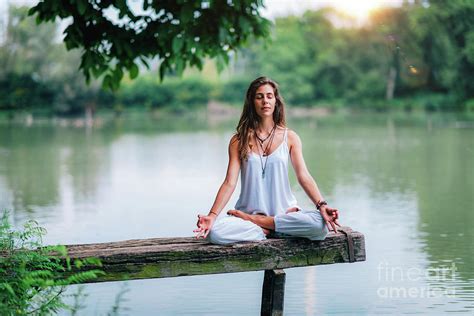 Woman Meditating By A Lake Photograph By Microgen Images Science Photo
