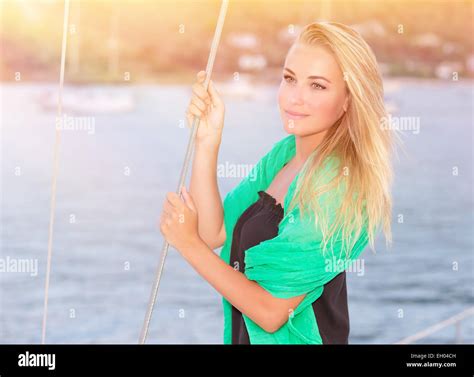 Portrait Of Pretty Dreamy Blond Girl Standing On The Deck Of Luxury