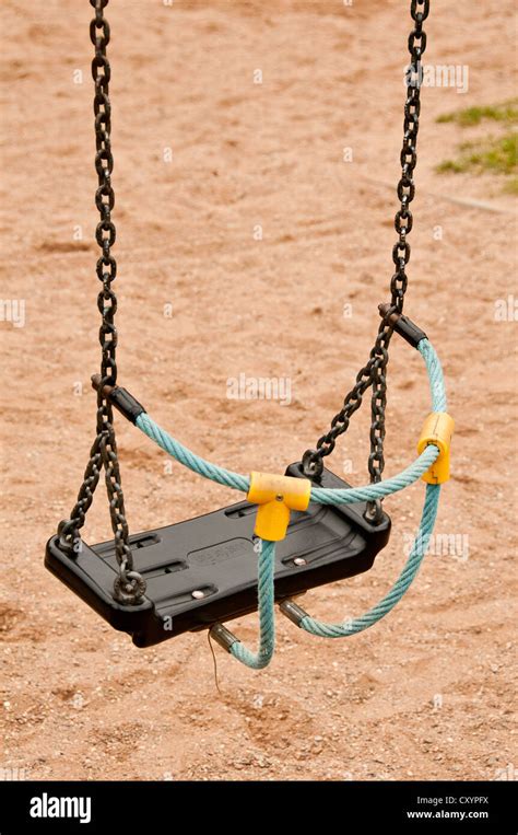 Empty Swing In A Playground Stock Photo Alamy