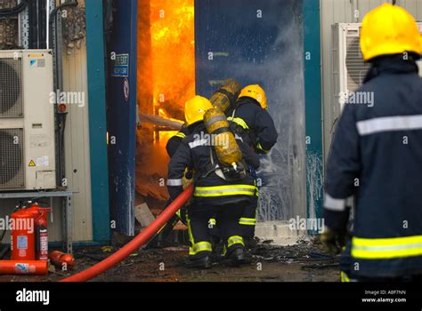 Fire Firefighters Entering Burning Building Through Fire Door One