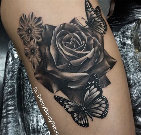 Realistic Black And Grey Rose Tattoo On A Thigh With Butterfly This